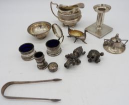 A GROUP OF MIXED SILVER ITEMS, including a boat form jug, weighted candlestick, three piece cruet