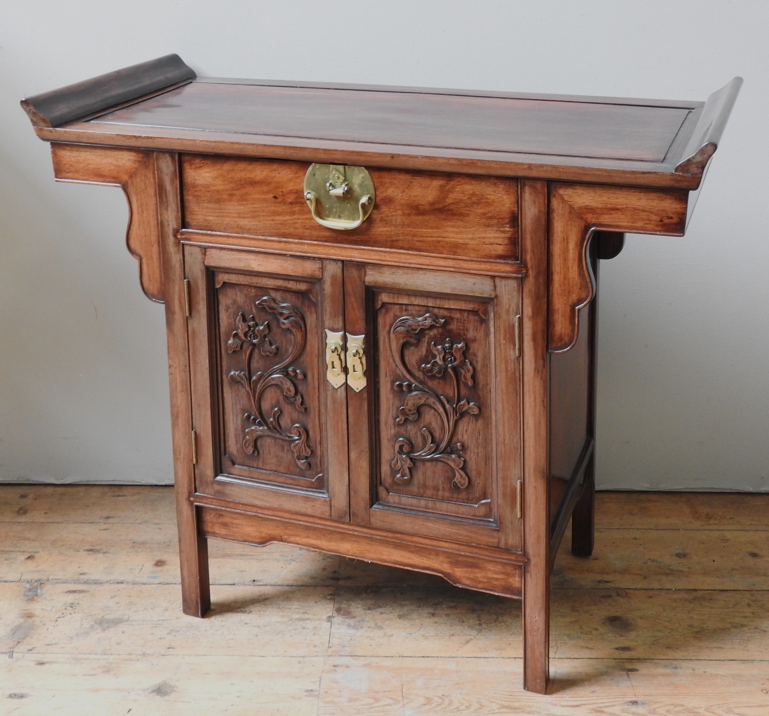 A CHINESE HARDWOOD COFFER, 20TH CENTURY, rectangular top with scroll form end brackets above a