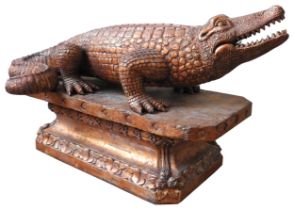 A LARGE CARVED WOODEN DECORATIVE MODEL OF AN ALLIGATOR, standing foursquare on a foliate carved