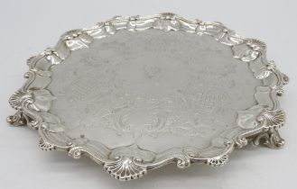 A VICTORIAN SILVER SALVER, with scrolling shell embellished rim and chased rocaille decoration