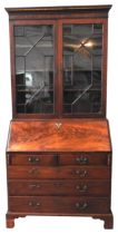 AN EARLY 19TH CENTURY MAHOGANY BUREAU BOOKCASE, the top section comprised of a dentil cornice