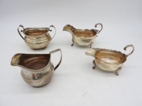 TWO SILVER SAUCEBOATS, BOAT FORM JUG AND BOAT FORM SUGAR BOWL, the two sauceboats with scroll