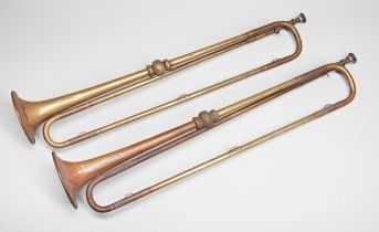 A PAIR OF HAWKES AND SON BRASS HERALDS TRUMPETS. 69 cms long Provenance: from the Private Collection