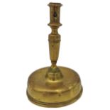 AN 17TH CENTURY CONTINENTAL BRASS CANDLESTICK, probably Dutch, on a distinctive bell shape base 21