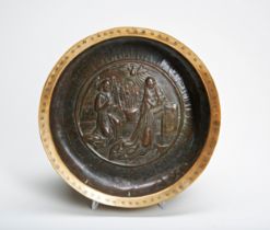 A NUREMBERG BRASS ALMS BOWL, probably 15th or 16th century, the centre, relief decorated with the