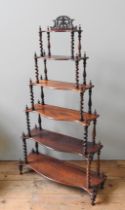 A VICTORIAN ROSEWOOD WHATNOT, consisting of six graduated serpentine shelves united by barley