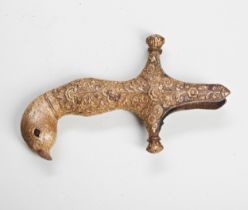 AN INDIAN GILT BRONZE SWORD HILT IN THE FORM OF A BIRD with handworked foliate decoration, the