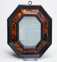 AN OCTAGONAL TORTOISESHELL VENEERED FRAME, probably 17th century the ebonised moulded frame with