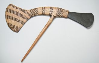 A PAPUA NEW GUINEA MOUNT HAGEN CEREMONIAL AXE, the woven haft with a green ‘slate’ blade. 85 cms