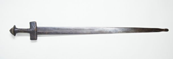 A NORTH WEST AFRICAN TUAREG DOUBLE EDGED SWORD with leather covered hilt, the blade marked with half