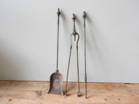 A SET OF THREE STEEL FIRE IRONS, 19TH CENTURY, with octagonal finial tops (79 cm long), along with a