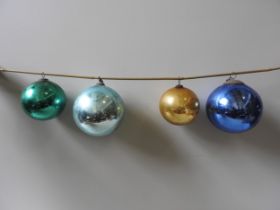 A BLUE 'WITCHES' BALL WITH SUSPENSION LOOP, ANOTHER IN LIGHTER BLUE AND TWO SMALLER IN GOLD AND