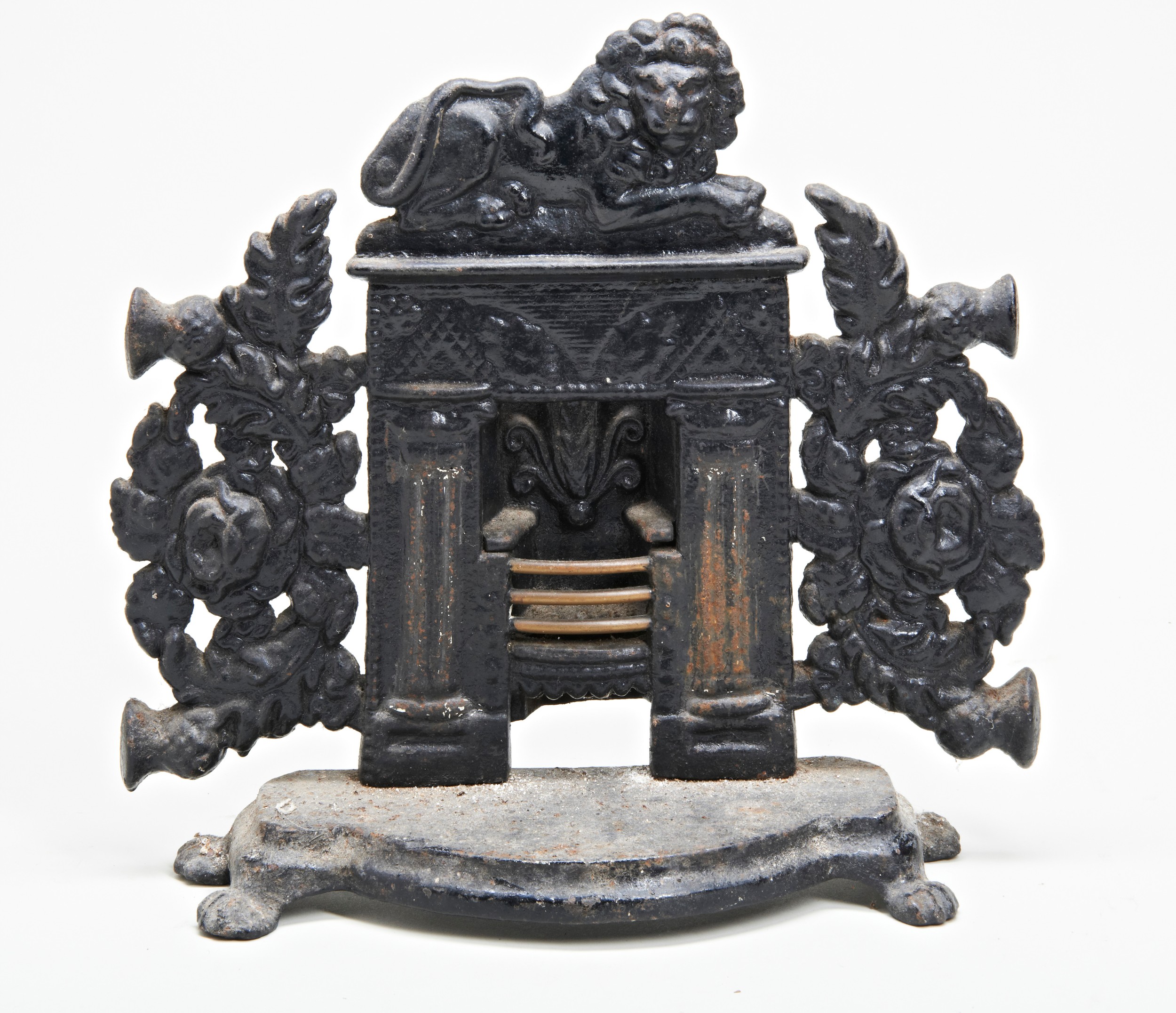 A VICTORIAN CAST IRON DOORSTOP IN THE FORM OF A FIREPLACE, THE GRATE WITH BRASS BARS. 32 x 33cms