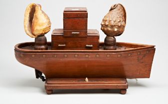 A SCRATCH BUILT LAMP IN THE FORM OF A BOAT, THE SHADES FASHIONED FROM TWO SHELLS AND FLANKING AN