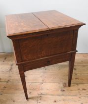 A VINTAGE OAK DRINKS CABINET, CIRCA 1930, square form with bi-fold hinged doors opening to reveal