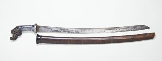 A LUWUK SWORD the intricately carved hilt with silver niello foliate decorated grip the ribbed steel