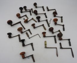 22 CRANK WINDING KEYS most with wooden handles (22) Provenance: from the Private Collection of the