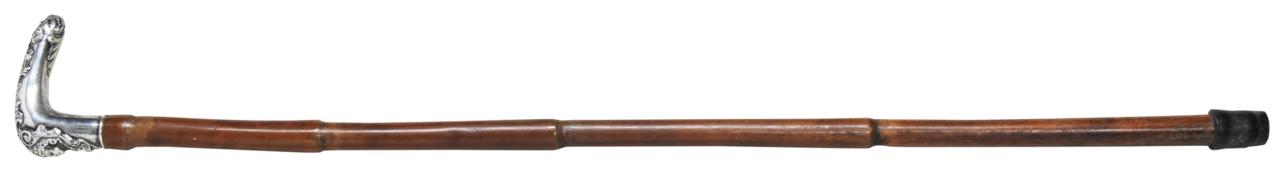 A 19TH CENTURY CANE with an ornate white metal handle decorated with a head of a grotesque and a - Image 2 of 2