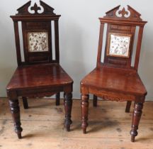 A PAIR OF 19TH CENTURY MAHOGANY HALL CHAIRS, Gothic style with a break arch top rail over a tile