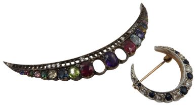 A SMALL DIAMOND AND SAPPHIRE CRESCENT SHAPED BROOCH set in yellow and white metal and a multi gem