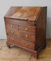 A WALNUT 19TH CENTURY BUREAU, the fall front opening to reveal a compartmented interior with an