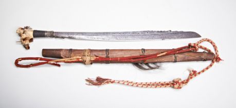 A GOOD DAYAK MANDAU SWORD the fine deer antler hilt with coloured fibre tufts the forged iron