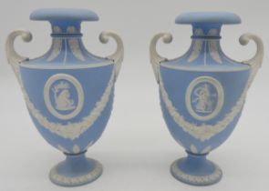 A PAIR OF WEDGWOOD JASPER WARE VASES of Amphora form with applied scrolling handles raised on a