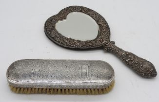 A SILVER MOUNTED HEART SHAPED HAND MIRROR AND AN ORNATE NIELLO DECORATED BRUSH, the mirror with