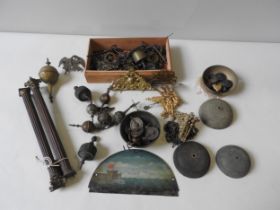 A BOX CONTAINING LONGCASE ITEMS. Bells, pulleys, spandrels, finials, a pair of fluted corinttian