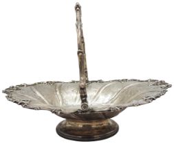 A GOOD VICTORIAN SILVER SWING-HANDLED BASKET; of ornate compartmental form on a raised foot,