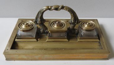 AN IMPRESSIVE LARGE BRASS INKSTAND, LATE 19TH CENTURY, the rectangular form stand with three glass