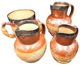 A THREE HANDLED 19TH CENTURY STONE WARE HARVEST TANKARD AND THREE GRADUATED HARVEST JUGS, all with