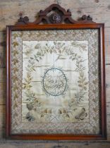 AN EARLY 19TH CENTURY EMBROIDERED SILK PANEL, a central cartouche reserve containing the initials