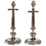 A pair of German silver candlesticks of tapered form upon circular scrolled bases. (H: 34cm), 981