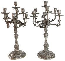 A good pair of German silver seven branch candelabrum with scrolled bases. Maker (Elimeyer