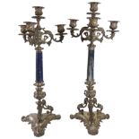 A pair of elaborate Italian silver four light candlesticks having Lapis Lazuli columns upon scrolled