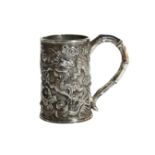 A small Chinese silver drinking vessel depicting dragons & mythical beasts with shaped handle, (H: 7
