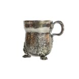 An unusual silver beaker/ cup with scrolled decoration of foliage upon tripod paw feet, 19th-century