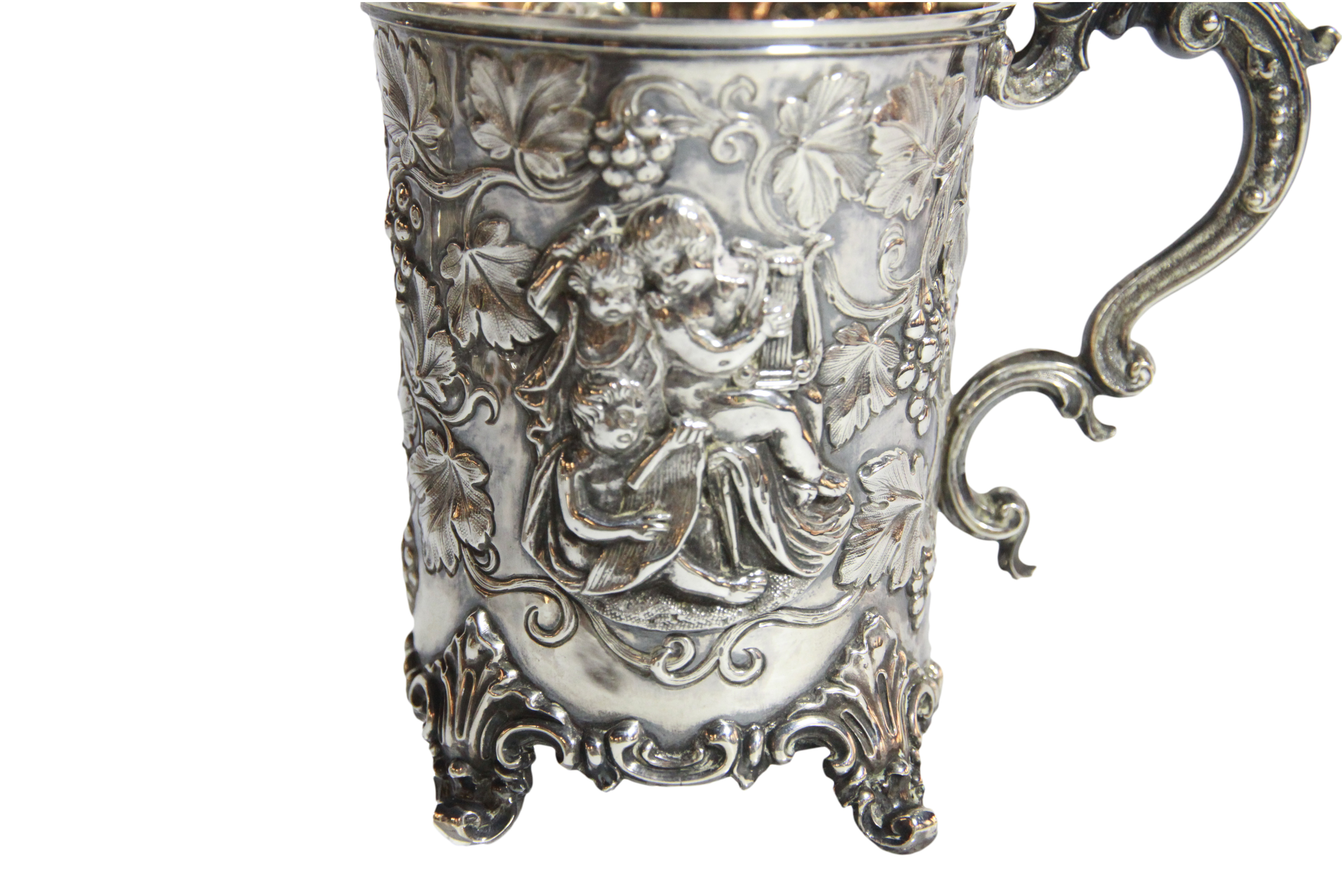 A superb silver beaker/ cup with cherub vine scrolled decoration upon four Roco scrolled feet, - Image 2 of 8