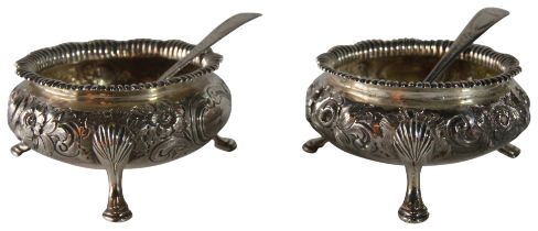 A pair of silver salts with foliate edge decoration upon tripod hoof feet. (London - 1852) - with