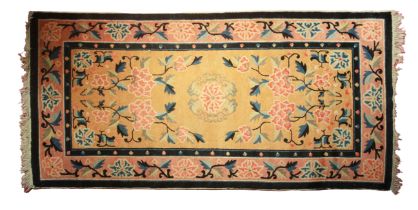 A good Caucasian yellow ground rug with stylised flowers with blue border, (L: 160cm, W: 80 cm)