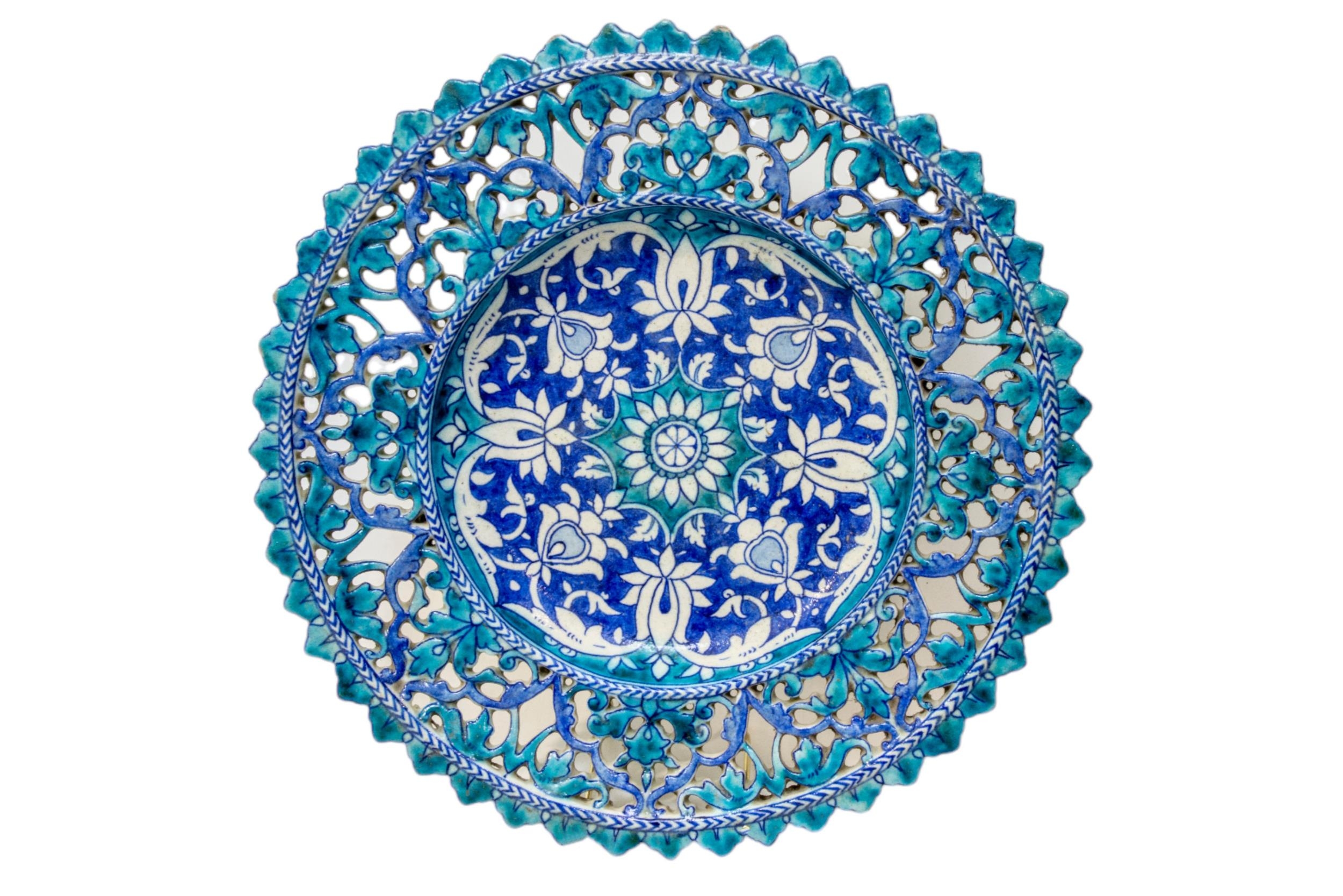 A PERSIAN/NEAR EASTERN ORNATE DISH, 19TH CENTURY, the centre painted with flower head decoration