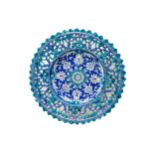 A PERSIAN/NEAR EASTERN ORNATE DISH, 19TH CENTURY, the centre painted with flower head decoration
