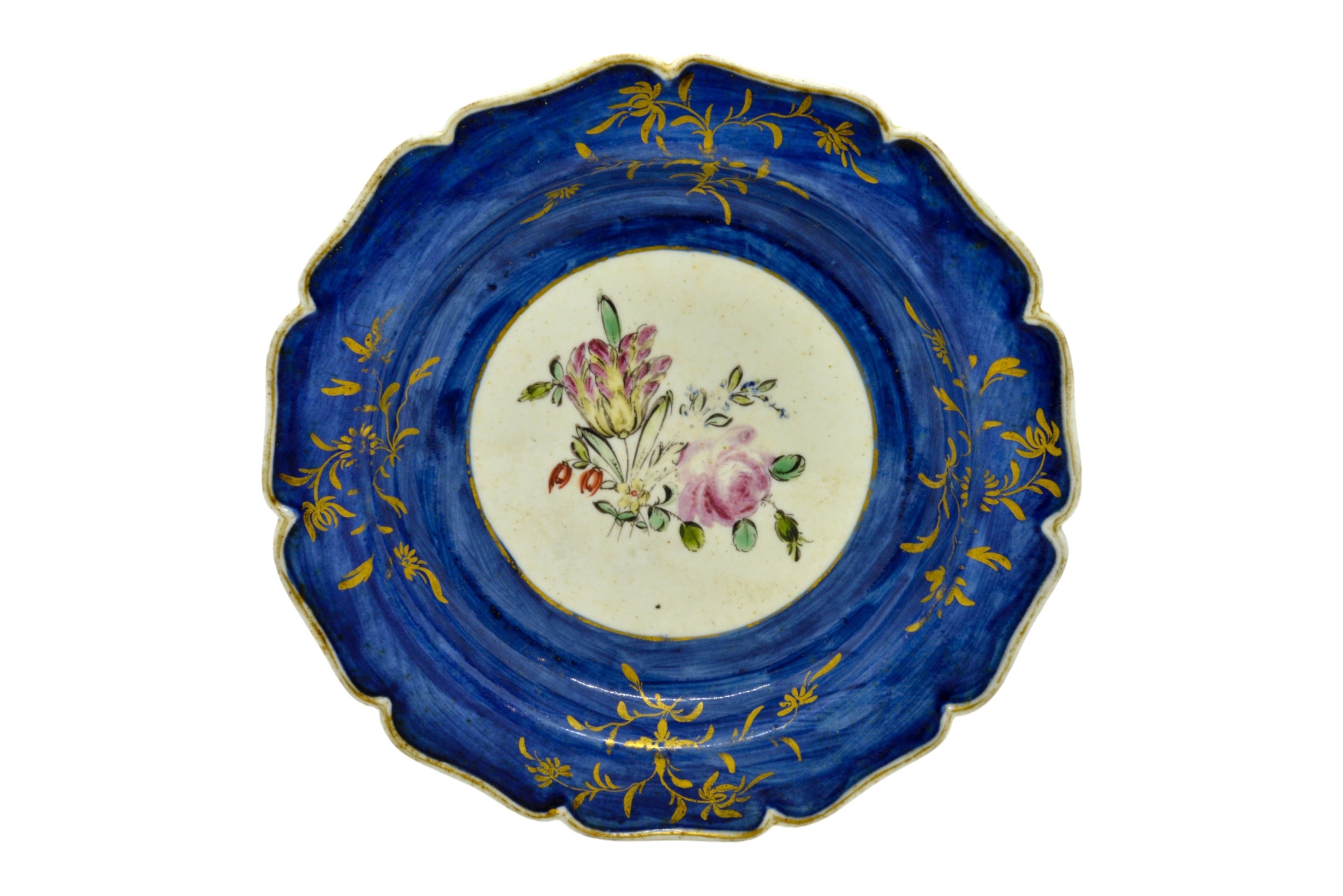 A MID 18TH CENTURY PLATE With central floral spray, 18cms wide