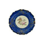 A MID 18TH CENTURY PLATE With central floral spray, 18cms wide