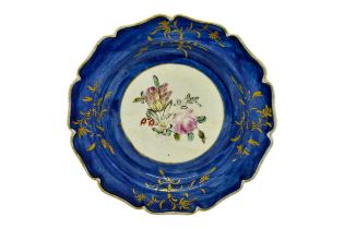 A MID 18TH CENTURY PLATE With central floral spray, 18cms wide