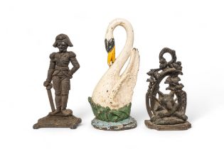 A CAST IRON DOORSTEP IN THE FORM OF A SWAN, another of a fox mask and another of a soldier. 40 cms