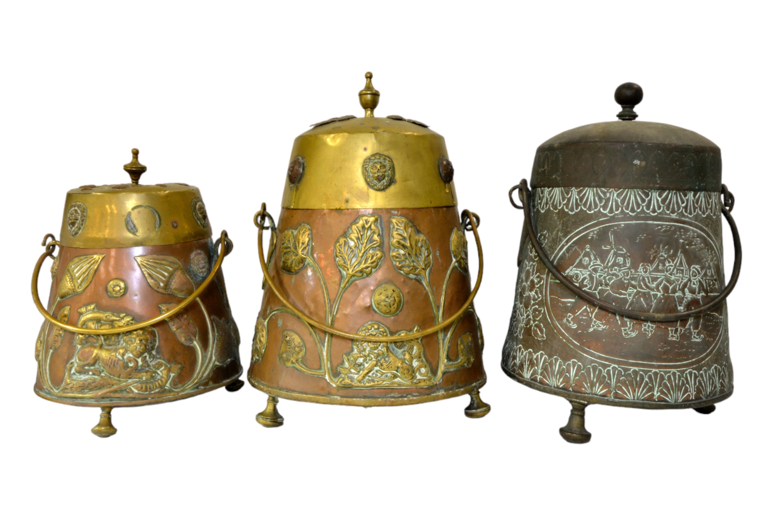 A DUTCH COPPER AND BRASS LIDDED COAL BUCKET  decorated with floral and animal appliques, another