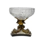 A GLASS CENTRE PIECE, the bowl supported on a triform base of three Gilded brass fish mounted on a