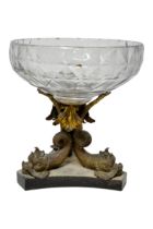 A GLASS CENTRE PIECE, the bowl supported on a triform base of three Gilded brass fish mounted on a
